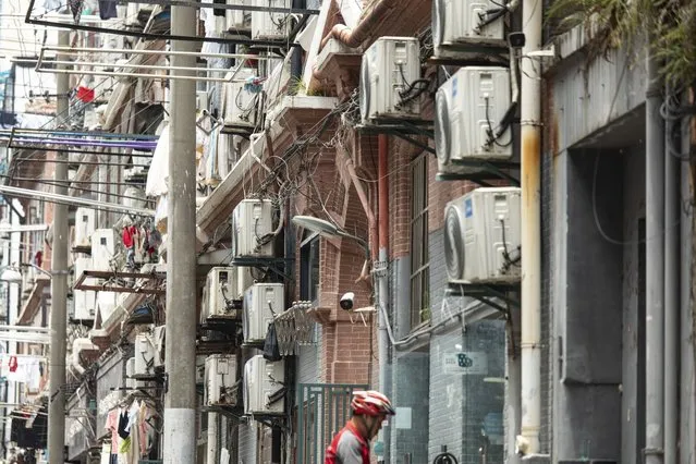 Air conditioner units at a building in Shanghai, China, on Friday, June 23, 2023. Extreme weather is already promising a fresh test of the electricity grid just months after heat waves and drought throttled hydropower and triggered widespread power shortages. (Photo by Qilai Shen/Bloomberg)
