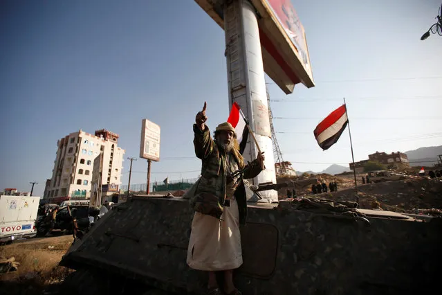 A follower of the Shi'ite Houthi movement gestures as he stands on a military vehicle near the site of a rally commemorating the death of Imam Zaid bin Ali in Sanaa, Yemen October 26, 2016. (Photo by Khaled Abdullah/Reuters)