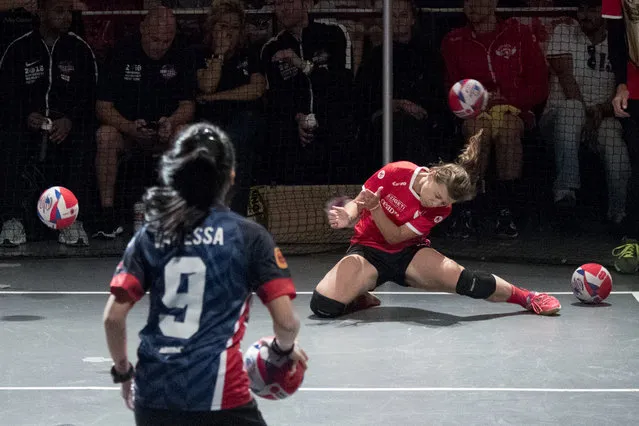 An Austria player, right, is hit by the ball during women's competition against Malaysia in the Dodgeball World Cup, Saturday, Aug. 4, 2018, in New York. (Photo by Mary Altaffer/AP Photo)