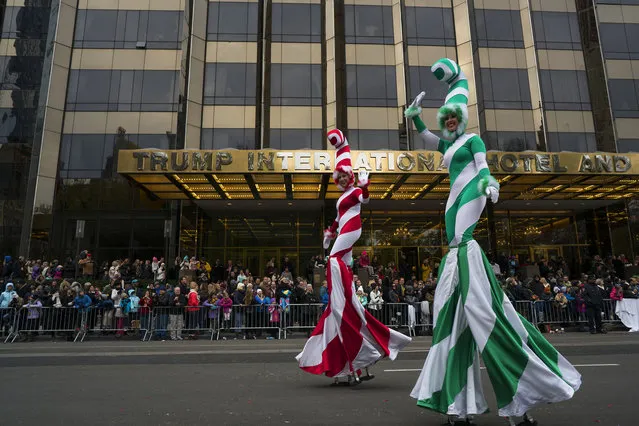 Participants dressed as candy canes stand tall above spectators along Central Park West during the Macy's Thanksgiving Day Parade in New York Thursday, November 24, 2016. (Photo by Craig Ruttle/AP Photo)