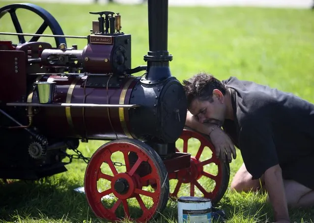 An exhibitor prepares a miniature steam engine to show at the Cornish Steam and Country Fair at the Stithians Showground on August 16, 2013 near Penryn, England. The annual show, now in 58th year, is one of Cornwall's largest outdoor events and is one of the UK's most popular and respected steam rallies. (Photo by Matt Cardy/Getty Images)