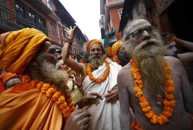 Hindu holy men, or sadhus, chant the name of Lord Shiva as they take part in a religious rally on the premises of Pashupatinath Temple in Kathmandu February 15, 2015. (Photo by Navesh Chitrakar/Reuters)