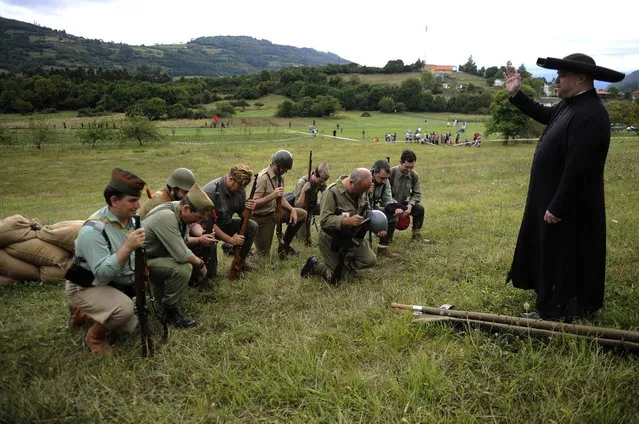 Actors take part in a re-enactment of the "Battle of Areces" that took place during the Spanish Civil War, in Grullos, north of Spain, September 14, 2013. The re-enactment of the historic 1937 battle was organised by the Frente del Nalon Association. (Photo by Eloy Alonso/Reuters)