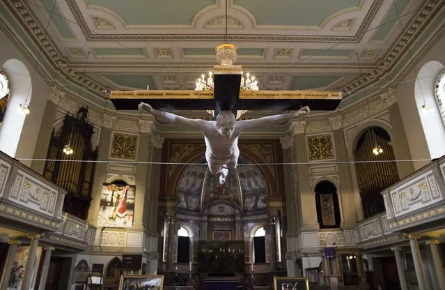 The work “For Pete's Sake”, a life size sculpture of a musician Pete Doherty crucified, hangs from the ceiling at St Marylebone Parish church in London, February 19, 2015. (Photo by Neil Hall/Reuters)