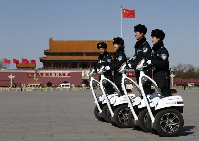 Police offices ride on motorized vehicles ahead of the opening session of Chinese People's Political Consultative Conference (CPPCC) at Tiananmen Square in Beijing, March 3, 2015.  REUTERS/Kim Kyung-Hoon 