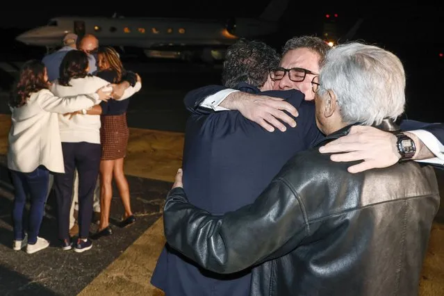 Family members embrace freed Americans Siamak Namazi, Morad Tahbaz and Emad Shargi, as well as two returnees whose names have not yet been released by the U.S. government, who were released in a prisoner swap deal between U.S and Iran, as they arrive at Davison Army Airfield, Tuesday, September 19, 2923 at Fort Belvoir, Va. (Photo by Jonathan Ernst/Pool via AP Photo)