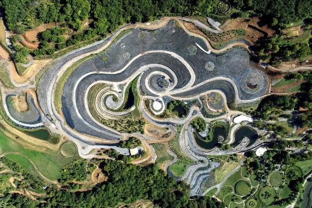 This photo taken by a drone shows an aerial view of a nature park shaped after Vincent van Gogh's painting “The Starry Night” near Visoko, Bosnia, Sunday, September 17, 2023. Fields of lavender, shrubs and lakes intertwined by a network of paths all recreate the famous painting in nature. (Photo by Armin Durgut/AP Photo)