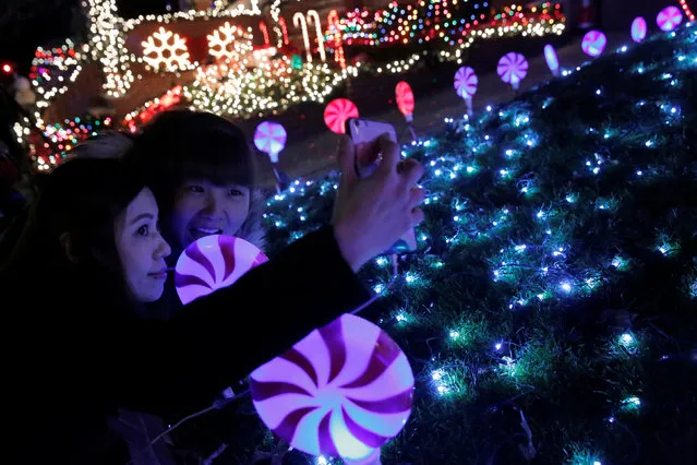Women pose for a selfie at the Dyker Heights Christmas Lights in the Dyker Heights neighborhood of Brooklyn, New York City, U.S., December 23, 2016. (Photo by Andrew Kelly/Reuters)
