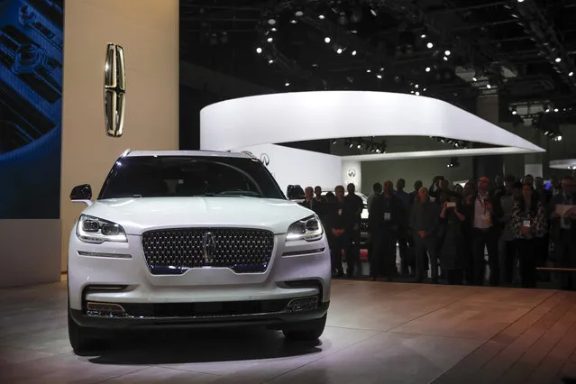 Attendees gather near the 2020 Lincoln Aviator during a news conference at the Los Angeles Auto Show Wednesday, November 28, 2018, in Los Angeles. (Photo by Jae C. Hong/AP Photo)