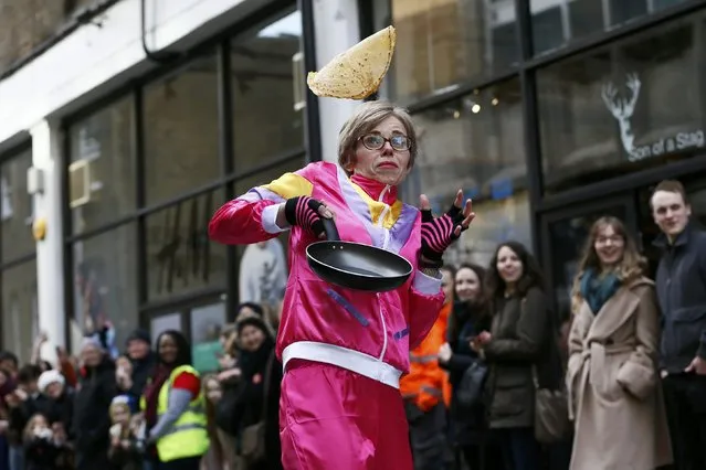 A participant takes part in the annual Great Spitalfields Pancake Race in aid of London's Air Ambulance in London, Britain February 9, 2016. (Photo by Stefan Wermuth/Reuters)
