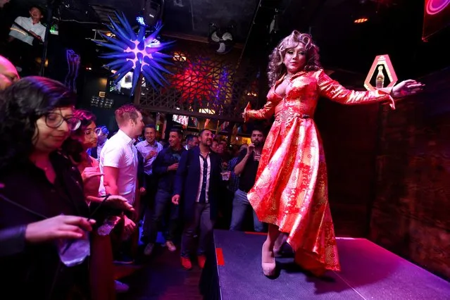 San Francisco drag queen Khmera Rouge performs onstage during the GAYPEC event hosted at Beaux Night Club in the Castro District of San Francisco, California, U.S., November 15, 2023. (Photo by Brittany Hosea-Small/Reuters)
