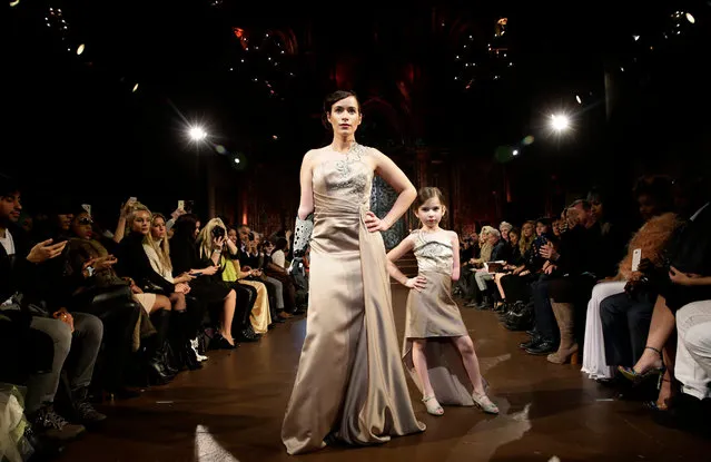 Bionic arm amputee model Rebekah Marine (L) and six-year old amputee model Gianna Schiavone (R) present creations from the Fall 2016 collection by FTL Moda during the New York Fall Fashion Week, in New York, New York, USA, 15 February 2016. The Fall 2016 collections are presented from 11 to 18 February. (Photo by Jason Szenes/EPA)