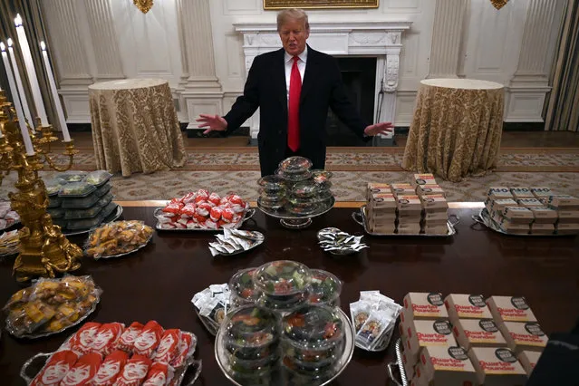 President Donald Trump talks to the media about the table full of fast food in the State Dining Room of the White House in Washington, Monday, January 14, 2019, for the reception for the Clemson Tigers. (Photo by Susan Walsh/AP Photo)