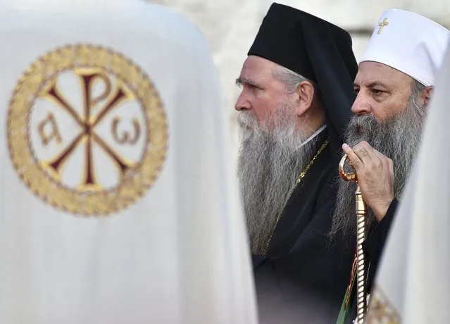 Head of the Serbian Orthodox Church, Patriarch Porfirije, right, and Mitropolitan Joanikije at the arrival ceremony in front of the Serbian Orthodox Church of Christ's Resurrection in Podgorica, Montenegro, Saturday, September 4, 2021. Serbian patriarch Porfirije arrives at Podgorica ahead of the inauguration of the new bishop of the Serbian Orthodox Church in Montenegro scheduled in Cetinje, sparking tensions. On Saturday, hundreds of protesters confronted the police in Cetinje and briefly removed some of the protective metal fences around the monastery where the inauguration of Mitropolitan Joanikije is supposed to take place. (Photo by Risto Bozovic/AP Photo)