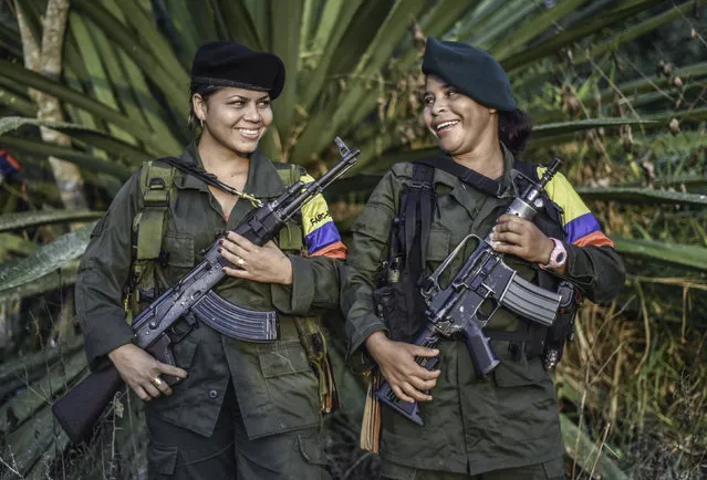 Manuela (L) and Marta, members of the Revolutionary Armed Forces of Colombia (FARC), pose for a picture at a camp in the Colombian mountains on February 18, 2016. Many of these women are willing to be reunited with the children they gave birth and then left under protection of relatives or farmers, whenever the peace agreement will put an end to the country's internal conflict. (Photo by Luis Acosta/AFP Photo)