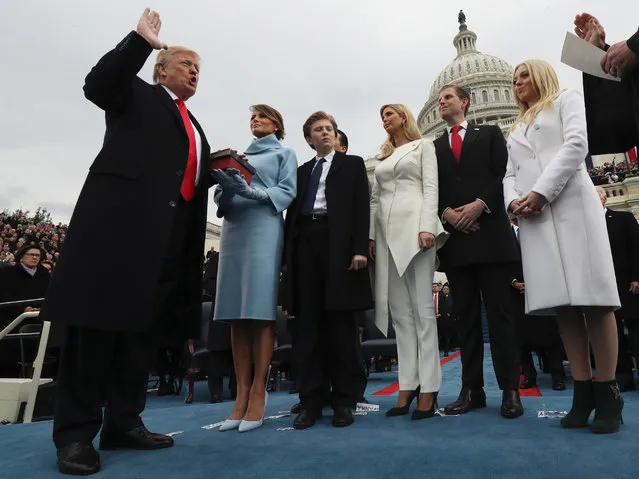 US President Donald Trump takes the oath of office as his wife Melania holds the bible and his children Barron, Ivanka, Eric and Tiffany watch as US Supreme Court Chief Justice John Roberts (R) administers the oath during inauguration ceremonies swearing in Trump as the 45th president of the United States on the West front of the US Capitol in Washington, DC, January 20, 2017. Donald Trump was sworn in as the 45th president of the United States Friday – ushering in a new political era that has been cheered and feared in equal measure. (Photo by Jim Bourg/AFP Photo)