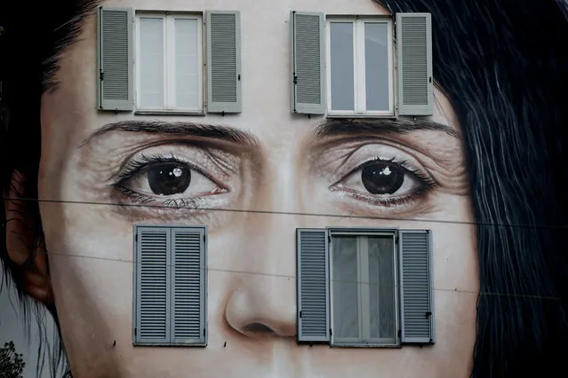 An art wall painting representing performance artist Marina Abramovic by Italian artist Maurizio Cattellan to publicize his upcoming exhibition The Artist is Present, in Shanghai, China, is displayed on a facade of a building, in Milan, Italy, Wednesday, September 19, 2018. (Photo by Luca Bruno/AP Photo)