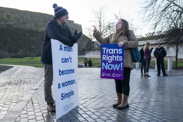 A member of the Scottish Family Party, left speaks with a supporter of the Gender Recognition Reform Bill (Scotland) during a protest outside the Scottish Parliament, ahead of a debate on the bill, in Edinburgh. Tuesday, December 20, 2022. A plan by Scotland’s government to make it easier for people to change gender has sparked acrimonious debate, with lawmakers arguing inside the Edinburgh parliament and rival groups of protesters demonstrating outside. A bill introduced by the Scottish National Party-led government will allow people to change gender by self-declaration, removing the need for a medical diagnosis of gender dysphoria.  (Photo by Jane Barlow/PA Wire via AP Photo)
