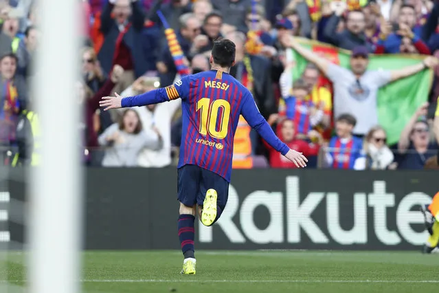 Barcelona's Lionel Messi celebrates after scoring the opening goal during a Spanish La Liga soccer match between FC Barcelona and Espanyol at the Camp Nou stadium in Barcelona, Spain, Saturday March 30, 2019. (Photo by Manu Fernandez/AP Photo)
