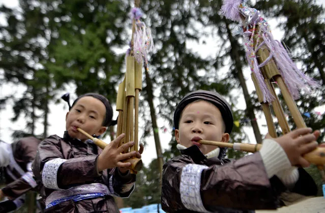 Children play Lusheng (reed-pipe wind instrument) during the Chinese Lunar New year holiday, in Rongshui, Guangxi Zhuang Autonomous Region, China, January 30, 2017. (Photo by Reuters/Stringer)