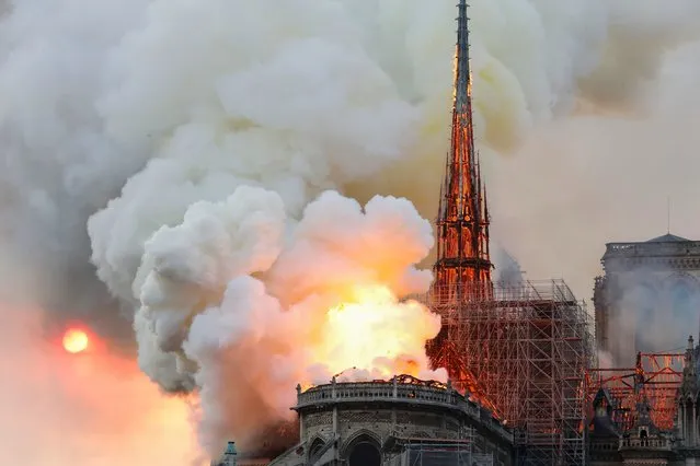 Smoke and flames rise during a fire at the landmark Notre-Dame Cathedral in central Paris on April 15, 2019, potentially involving renovation works being carried out at the site, the fire service said. (Photo by Pierre Galey/AFP Photo)