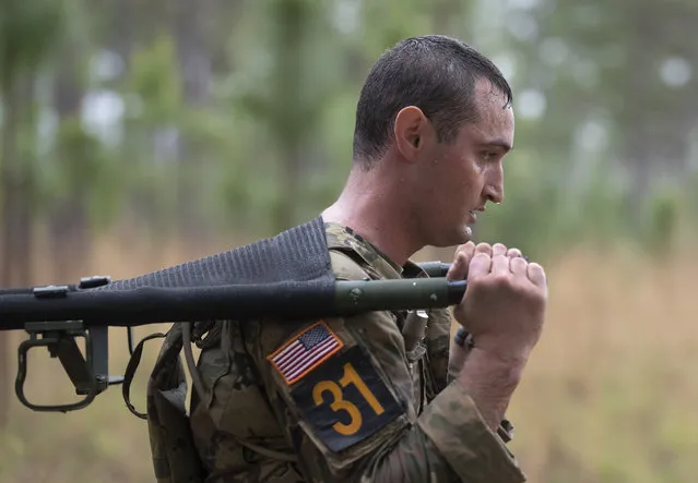 A Ranger carries weights on stretcher during a weighted carry portion of the Best Ranger competition Friday, April 12, 2019, in Fort Benning, Ga. (Photo by John Bazemore/AP Photo)