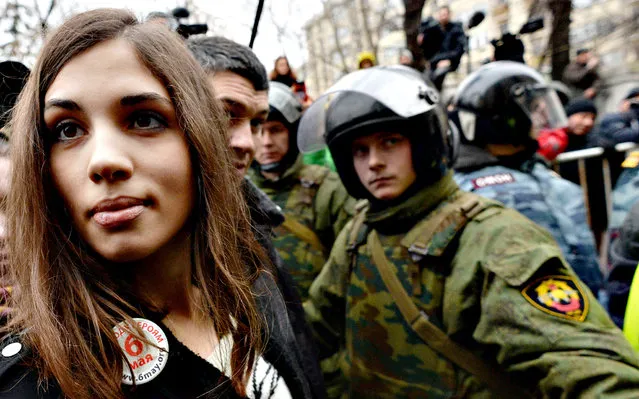 Russian punk group p*ssy Riot member Nadezhda Tolokonnikova looks on as she stands outside Zamoskvoretsky district court in Moscow, on February 24, 2014, during a protest against the trial of eight people accused of instigating mass riots after an opposition rally on Moscow's on Bolotnaya square turned violent on the eve of Vladimir Putin's inauguration as president in 2012. (Photo by Vasily Maximov/AFP Photo)