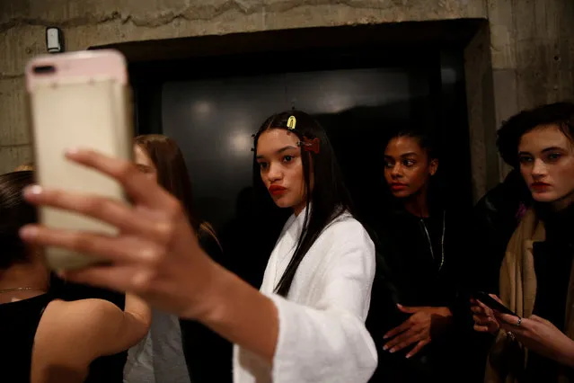 A model takes a selfie backstage at the Topshop Unique catwalk show during London Fashion Week in London, Britain February 19, 2017. (Photo by Neil Hall/Reuters)