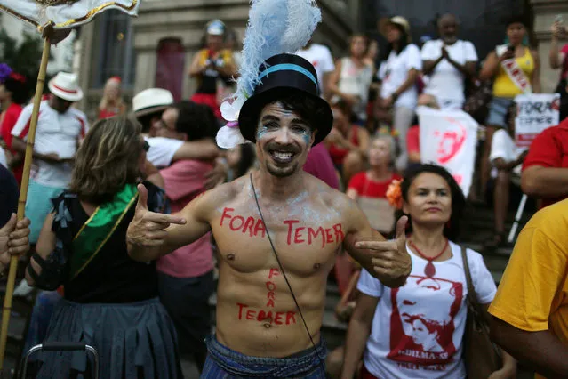 Revellers take part in block party “Fora Temer” (Out Temer), referring to Brazil's President Michel Temer, during pre-carnival festivities in Rio Janeiro, Brazil February 24, 2017. (Photo by Pilar Olivares/Reuters)