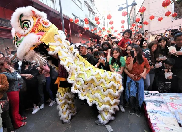 People participate in the dragon parade during Chinese Lunar New Year of the Rabbit celebrations in the Barrio Chino neighborhood in Mexico City, Mexico on January 22, 2023. (Photo by Luis Cortes/Reuters)