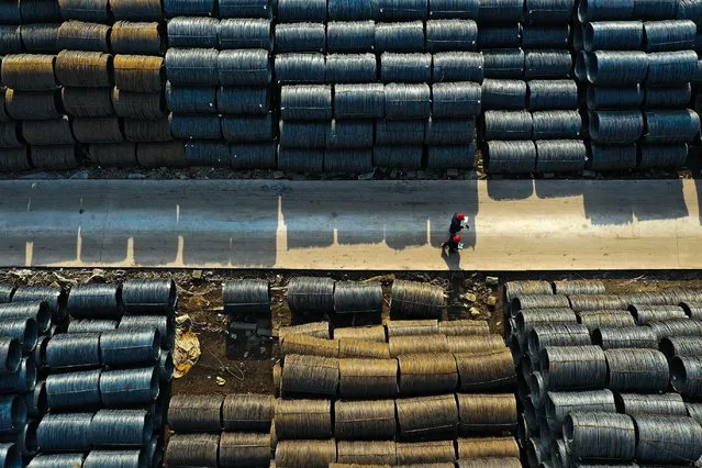 An aerial view shows people walking at a wholesale steel market in Shenyang, in northeastern China's Liaoning province on April 11, 2024. (Photo by AFP Photo/China Stringer Network)