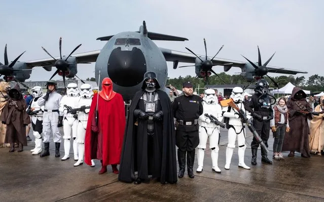 Visitors in Star Wars costumes pose in front of a Herkules plane during the “Tag der Bundeswehr” (Day of the German Armed Forces) at the air base in Fassberg, northern Germany, on June 15, 2019. (Photo by Peter Steffen/dpa/AFP Photo)