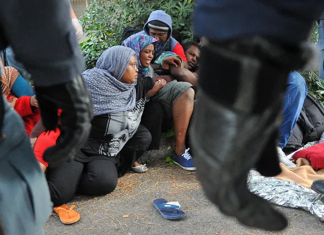 Italian Police remove migrants in Ventimiglia, at the Italian-French border Tuesday, June 16, 2015. Police at Italy's Mediterranean border with France have forcibly removed some of the African migrants who have been camping out for days in hopes of continuing their journeys farther north. The migrants, mostly from Sudan and Eritrea, have been camped out for five days after French border police refused to let them cross. (Luca Zennaro/ANSA via AP)