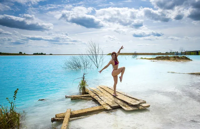 In this undated handout photo taken by mrwed54, a woman poses for a photo by a lake in the Siberian city of Novosibirsk, about 2,800 kilometers (1,750 miles) east of Moscow, Russia. Thousands of Novosibirsk residents, from scantily clad women to newlyweds have been instagramming selfies near the lake nicknamed the “Siberian Malvides” after the far-flung tropical islands in the Indian Ocean. This is in fact is a man-made dumb of coal from a nearby power station that provides for most of Novosibirsk’s energy needs. Environmentalists are warning people against coming into contact with the water. (Photo by mrwed54 via AP Photo)