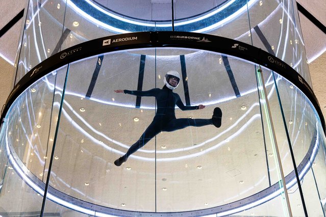 An athlete performs during the freestyle competition of the fifth FAI World Cup of Indoor Skydiving in Macau on April 19, 2024. (Photo by Eduardo Leal/AFP Photo)
