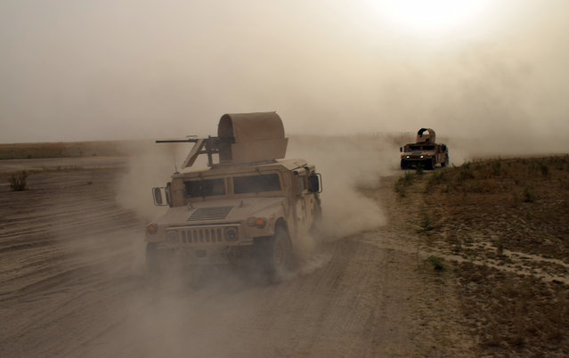 Iraqi army Humvees race toward the front lines on the outskirts of Ramadi during heavy clashes with Islamic State group militants in this September 12, 2015, file photo. The fighting eventually led to the recapture of the city from the extremists. After the massive destruction wreaked on Ramadi, Iraqi and coalition officials are rethinking tactics as they prepare for an assault to retake the biggest IS-held prize, the northern city of Mosul. (Photo by AP Photo)