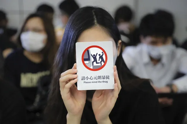 Demonstrators stand during a protest at the Yuen Long MTR station, where demonstrators and others were violently attacked by men in white T-shirts following an earlier protest in July, in Hong Kong, Wednesday, August 21, 2019. Japan's top diplomat on Tuesday told his Chinese counterpart that Japan is “deeply concerned” about the continuing protests in Hong Kong. (Photo by Kin Cheung/AP Photo)