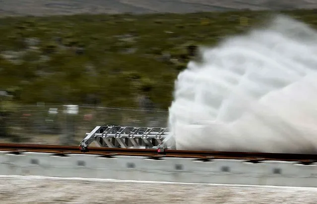 A sled speeds down a track during a test of a Hyperloop One propulsion system, Wednesday, May 11, 2016, in North Las Vegas, Nev. The startup company opened its test site outside of Las Vegas for the first public demonstration of technology for a super-speed, tube based transportation system. (Photo by John Locher/AP Photo)