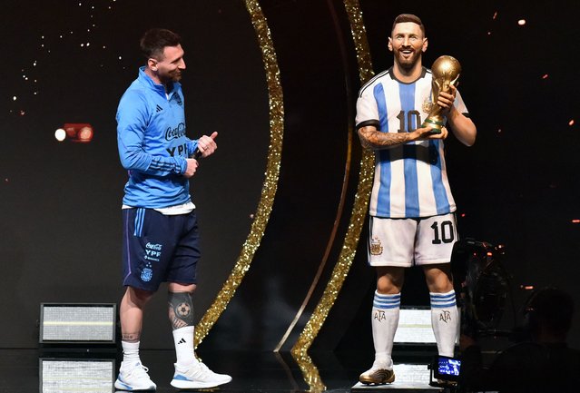 Argentina's forward Lionel Messi looks at a stature of himself during a tribute by Conmebol to the members of the Argentine national team for winning the Qatar 2022 World Cup, before the draw of the group phases of the Libertadores and Sudamericana football tournaments, at Conmebol's headquarters in Luque, Paraguay, on March 27, 2023. (Photo by Norberto Duarte/AFP Photo)