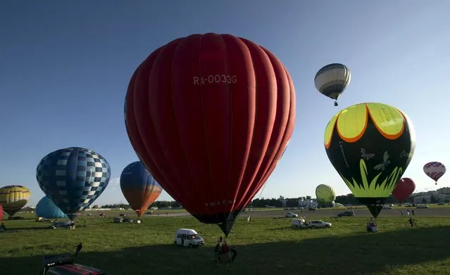Hot air balloons are seen at the Cup Hot Air event during the Air Sports festival titled “70 Years of Peaceful Sky” in Minsk, Belarus July 18, 2015. (Photo by Vasily Fedosenko/Reuters)