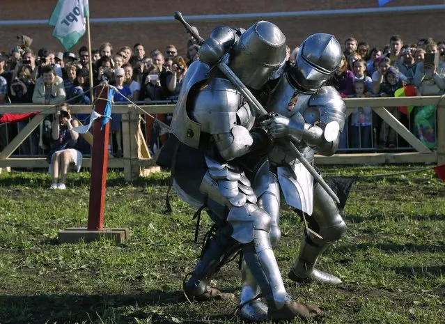 Members of medieval knights historical clubs fight during a festival on the activity in St.Petersburg, Russia, Sunday, July 19, 2015. (Photo by Dmitry Lovetsky/AP Photo)