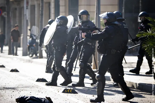 Riot Police clash with student demonstrators during a demonstration on February 2012 in Barcelona