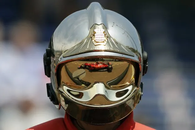 Ferrari driver Kimi Raikkonen of Finland is reflected on a firefighter helmet as he steers his car during the second free practice at the Formula One Grand Prix at the Monaco racetrack in Monaco, Thursday, May 25, 2017. The Formula one race will be held on Sunday. (Photo by Frank Augstein/AP Photo)