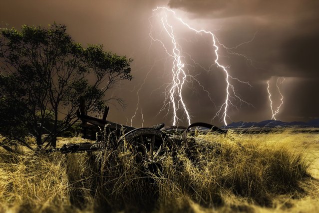 A thrill-seeking storm chaser captured the precise moment these giant lightning bolts lit up dark skies in a series of incredible storms. (Photo by Craig Eccles/Solent News & Photo Agency)