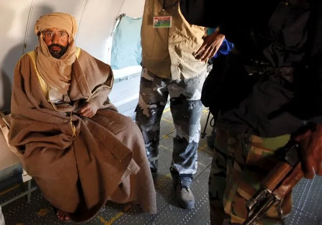 Saif al-Islam Gaddafi is pictured sitting in a plane in Zintan, Libya in this November 19, 2011 file photo. The Libyan court has sentenced Saif to death. The verdict was passed on Saif in absentia since he has been held since 2011 by a former rebel group in Zintan that opposes the Tripoli government. (Photo by Ismail Zitouny/Reuters)