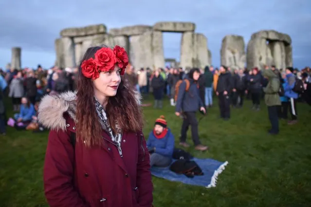 People gather at Stonehenge in Wiltshire on December 22, 2019, to mark the winter solstice, and to witness the sunrise after the longest night of the year. (Photo by Ben Birchall/PA Images via Getty Images)