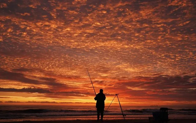 A fisherman on Whitley Bay beach in Northumberland, England at sunrise, October 5, 2019. (Photo by Owen Humphreys/PA Images via Getty Images)