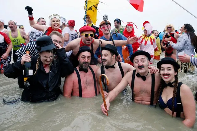 People wearing costumes participate in a traditional New Year's Day swim in Dunkirk, France on January 1, 2020. (Photo by Pascal Rossignol/Reuters)
