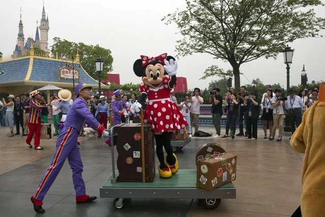 A Disney character takes part in a parade on the eve of the opening of the Disney Resorts in Shanghai, China, Wednesday, June 15, 2016. The debut of Shanghai Disneyland offers Walt Disney Co. “incredible potential” for boosting its brand in the world's most populous market, Disney's chief executive said Wednesday ahead of Thursday's grand opening for the $5.5 billion park. (Photo by Ng Han Guan/AP Photo)