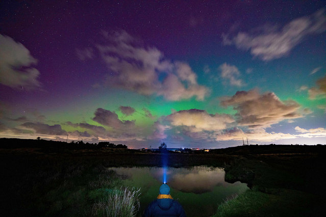 A Coronal Mass Ejection from the sun has provided a spectacular Auroa Borealis or Northern Lights over the UK on October 10, 2024. The Northern Lights or Aurora Borealis viewed from Halkyn Mountain in Flintshire, Wales as the photographer watches in awe. (Photo by DGDImages/Alamy Live News)